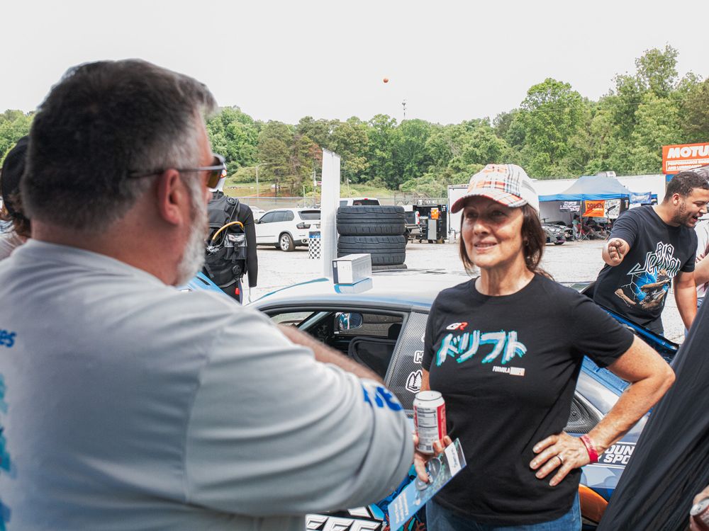 Two people talking at the Race to Reef trackside footprint
